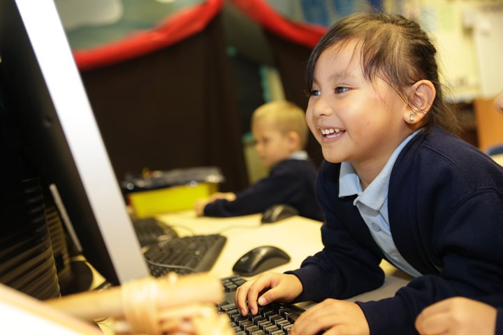 Child using a computer in school