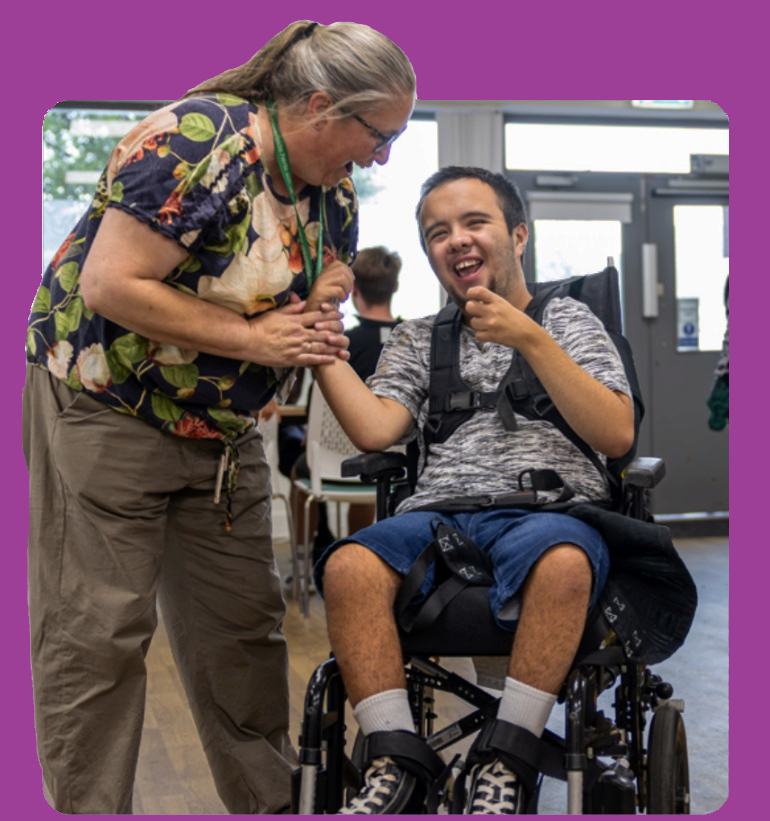 Woman laughing with man in wheelchair
