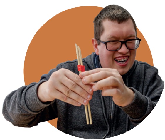 Man doing some crafts with wooden sticks