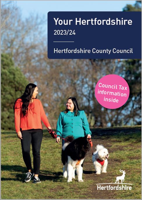 Your Hertfordshire front cover - Young lady and carer walking dogs in the park