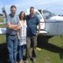 East Herts day service members standing by a small airplane.