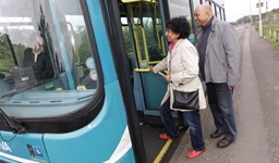 Older couple getting on a bus