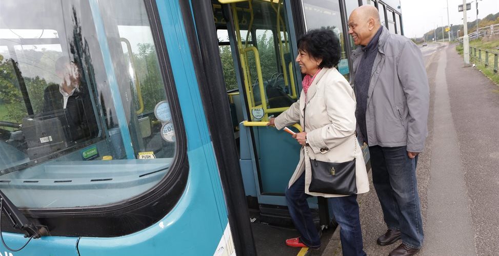 Older couple getting on a bus