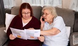 Two women looking at a letter