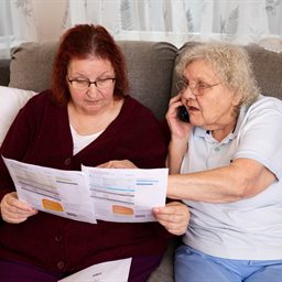 Two women looking at a letter