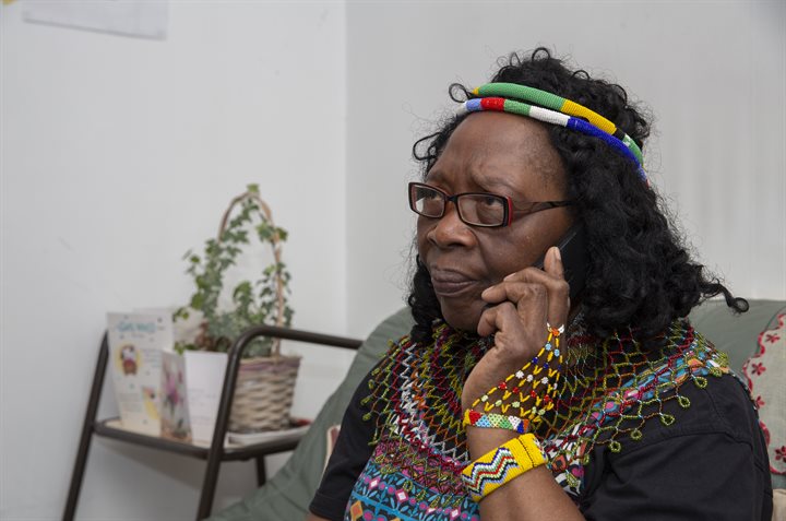 Older woman frowning and speaking on the phone