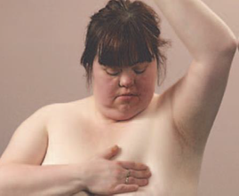 Woman checking breasts for lumps