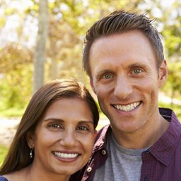 A couple smiling at the camera