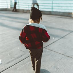 Child walking towards a sea front