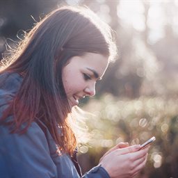 Girl reading a text on her phone
