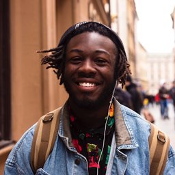 Teenager wearing headphones and smiling