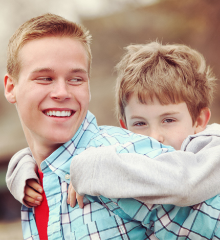 Older boy with younger boy on his back