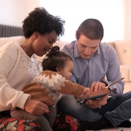 Couple reading to a baby