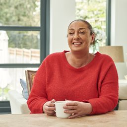 Woman smiling with a cup of tea