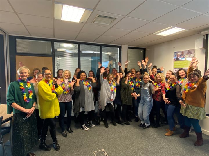 Ohana parent support volunteers standing in an office all waving