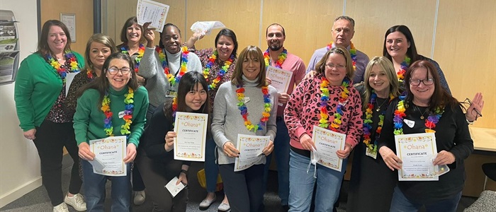 A group of Ohana volunteers holding their certificates and smiling.