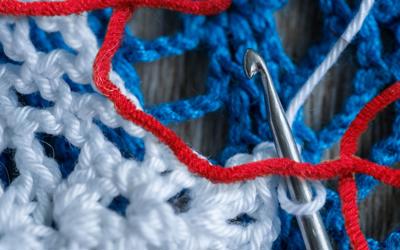 red white and blue yarn and crochet needle