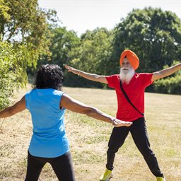 Man wearing a turban and woman doing star