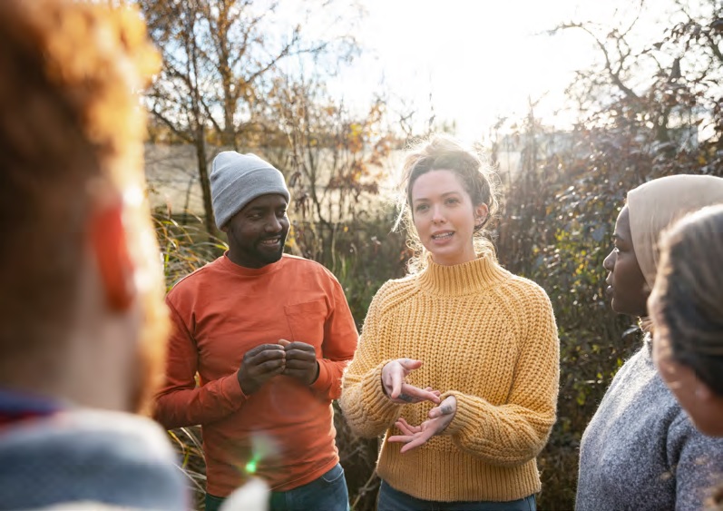 A group of volunteers talking at a community farm