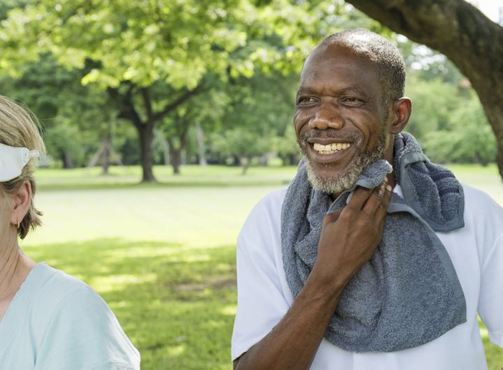 Older man in a park with a sports towel