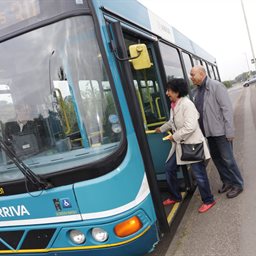 2 people boarding a bus