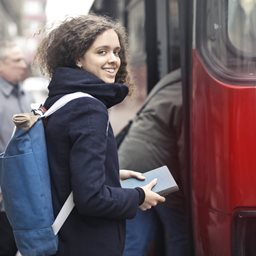 Teenager getting on a bus