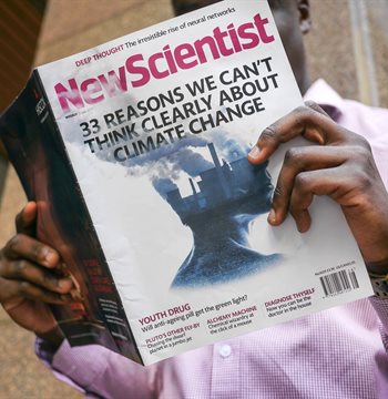 Man reading New Scientist magazine