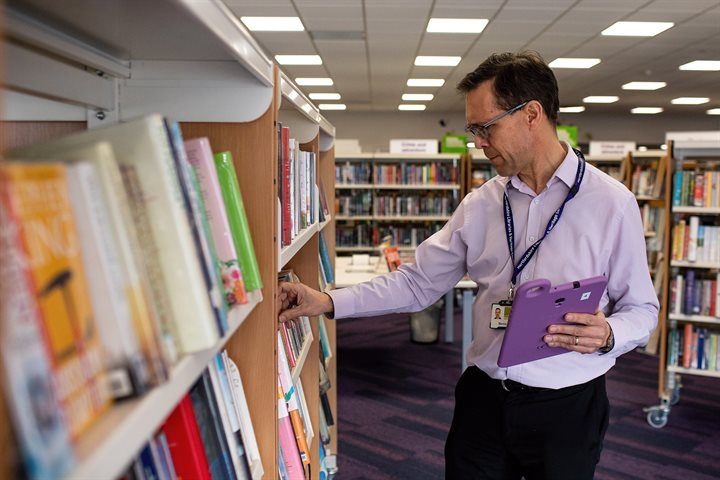 Librarian checking book stock