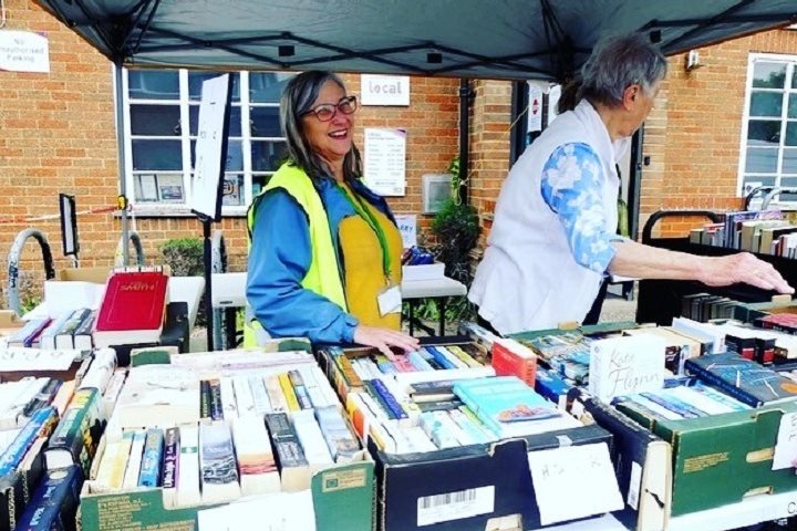 Volunteer selling old library stock