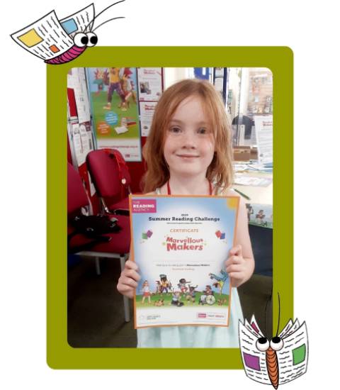 Summer Reading Challenge completer holding certificate up