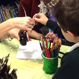 Child writing with a quill and ink