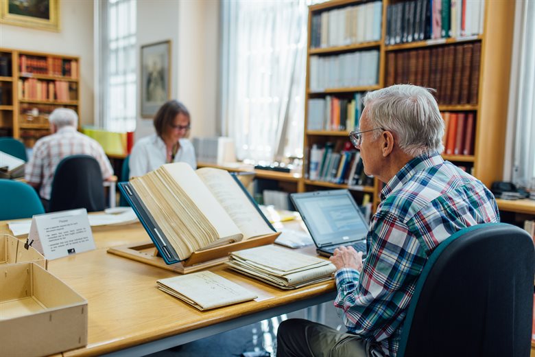 Man searching the family history archives