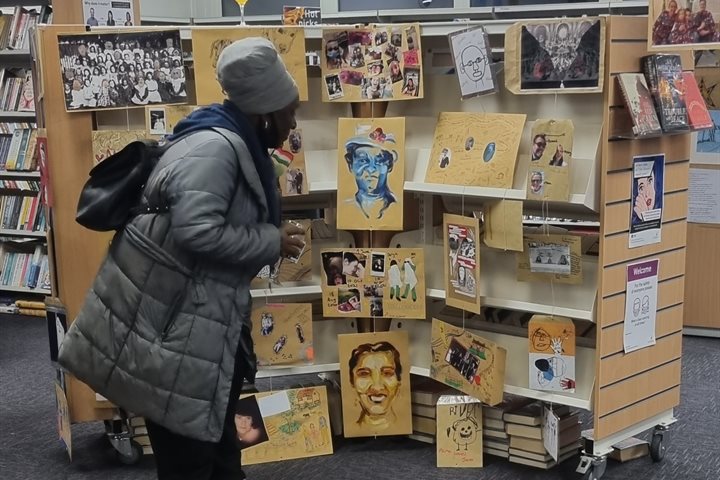 Woman browsing an exhibition in a library
