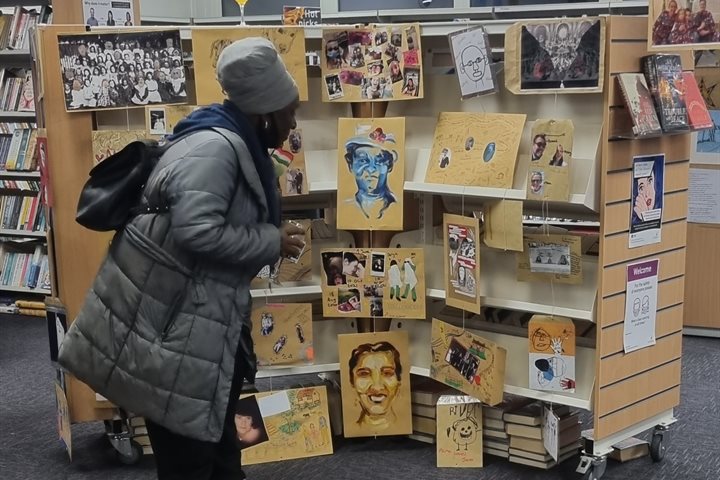 Woman browsing an exhibition in a library