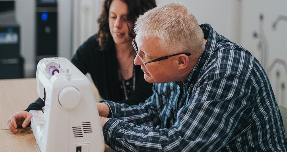 People using a sewing machine at Hemel Hempstead Library CreatorSpace