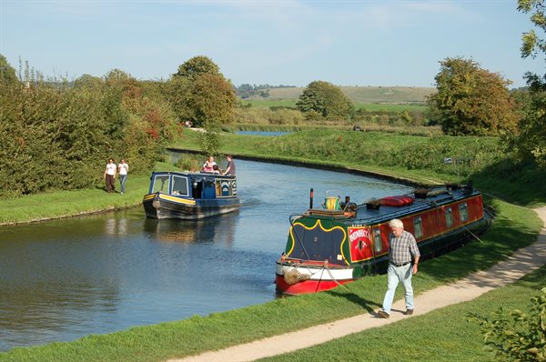 A man walking along the Grand Union Canal