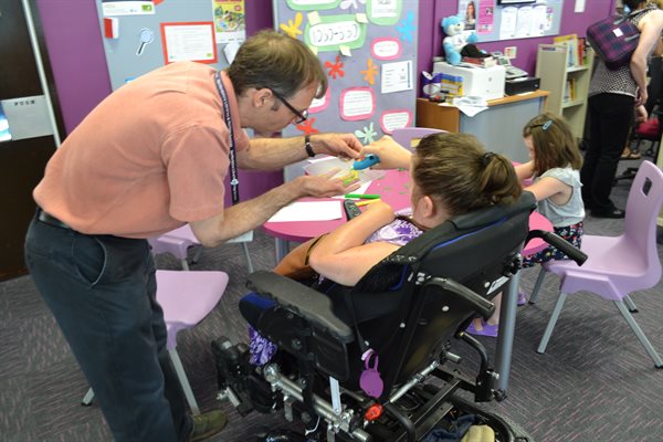 person in wheelchair using creator space
