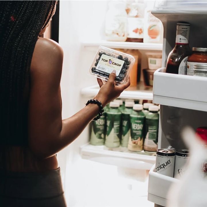 A woman looking in a fridge
