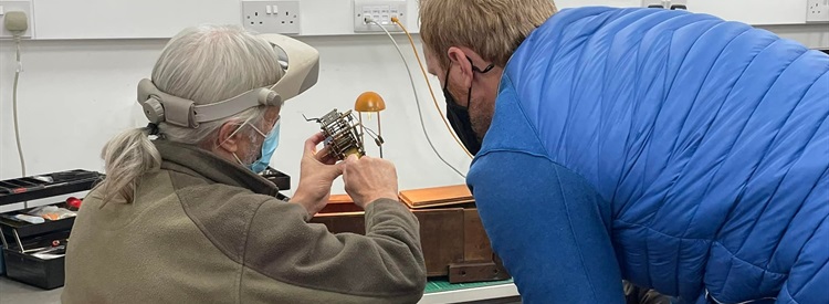 volunteer fixing a clock