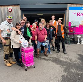 Group of people outside a reuse shop