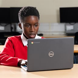 School boy using a laptop