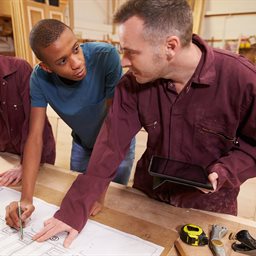 Carpenter teaching young people