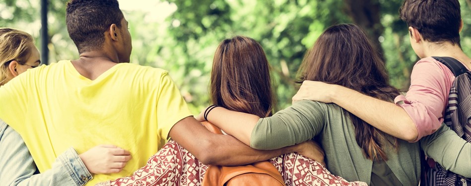 Young people hugging with backs to camera