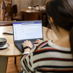 Woman using laptop in cafe