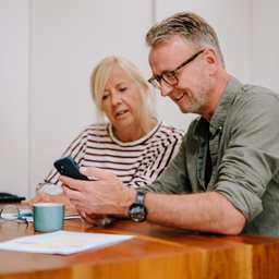Man and woman looking at a mobile phone