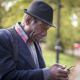 Man using a phone in a park