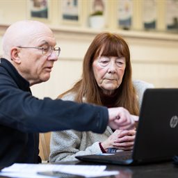 Older man and woman using a laptop
