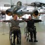 Two Broxbourne day service members in front of a plane.