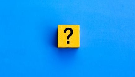 Yellow cube with a question mark on a blue background.