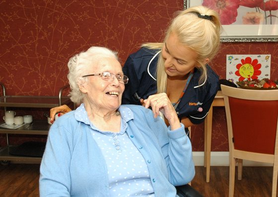 Carer-with-lady-in-chair-560x396